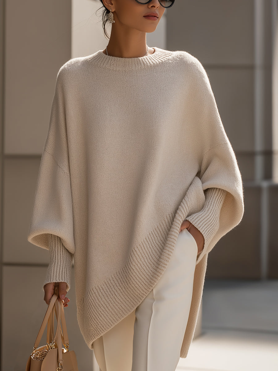 Women's oversized knit sweater with crew neckline, long sleeves and asymmetric hem