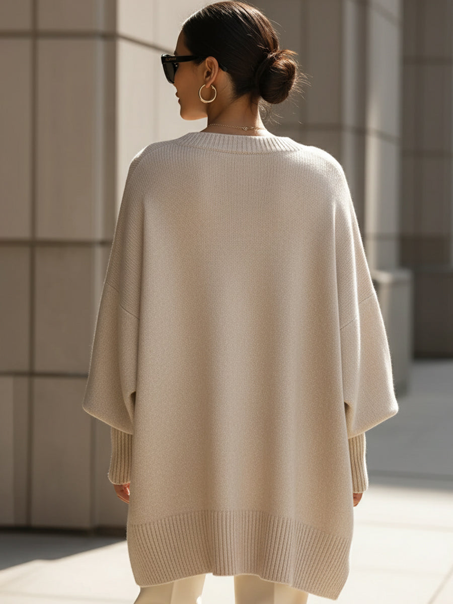 Women's oversized knit sweater with crew neckline, long sleeves and asymmetric hem