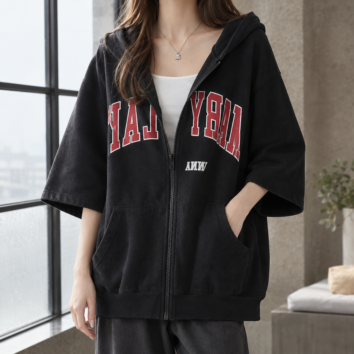 Women's oversized hooded zip-up hoodie with elbow sleeves and letter graphics